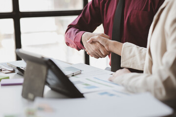Business investor group holding hands, Two businessmen are agreeing on business together and shaking hands after a successful negotiation. Handshaking is a Western greeting or congratulation.