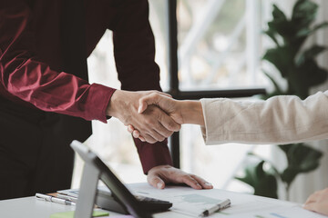 Business investor group holding hands, Two businessmen are agreeing on business together and shaking hands after a successful negotiation. Handshaking is a Western greeting or congratulation.