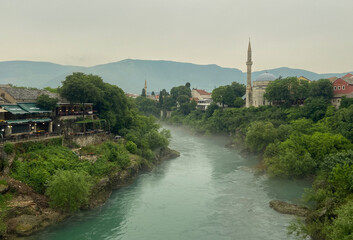Fototapeta premium Fog over the river in Mostar in Bosnia and Hercegovina 