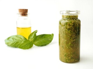 Homemade basil olive oil in a bottle on a White background 