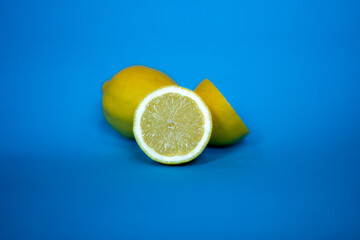 Yellow lemons on a contrasting blue background.