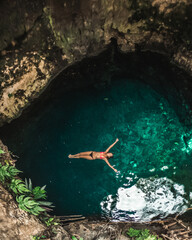 A woman floats in a mexican cenote