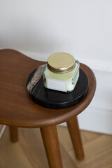 A candle stands on a stone stand in the room