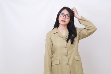 Confused young civil servant woman standing while holding her head and glancing above