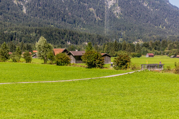 Fototapeta na wymiar Barns and meadows in Loisach valley, Germany