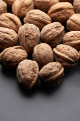 Whole walnuts nuts with shells close-up background studio shot