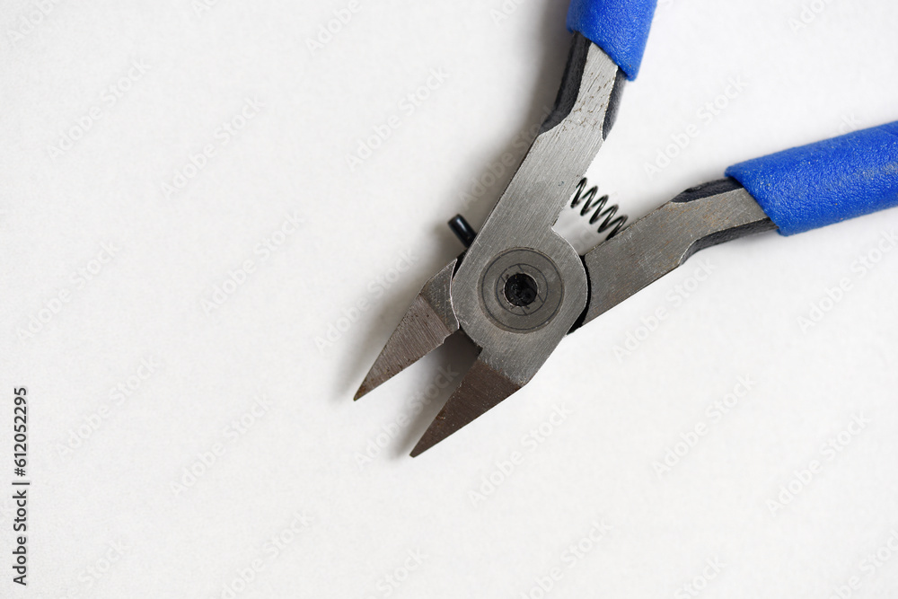 Wall mural close up pliers lay on white background ready for plastic model kit work