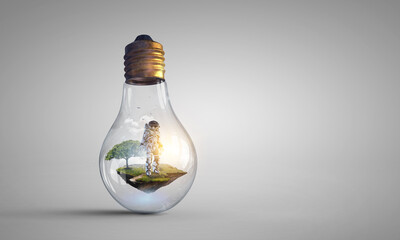 Spaceman inside light bulb . Mixed media