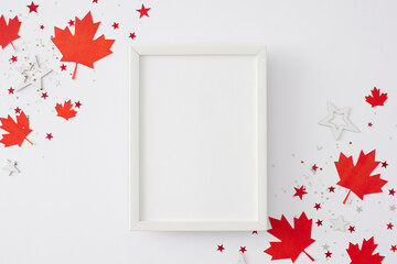 Canada Day party theme. Top view flat lay of red maple leaves, red, white confetti on white...