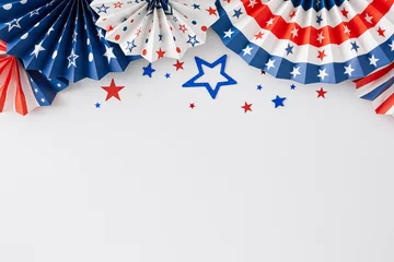 4th of July party concept. Top view flat lay of paper fans, star-shaped confetti on white background with blank space for text or ads © Goncharuk film