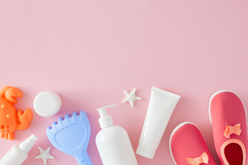 Idea for summer skincare for little ones. Top view flat lay of cosmetic bottles without label, sandbox toys, pink shoes, starfish on pastel pink background with space for branding or promo