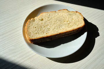 Fresh sliced bread on toast on plates on a light background. Sweet pastries. Food and nutrition concept
