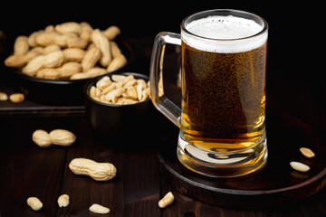 Mug of beer with foam and peanuts Pub background