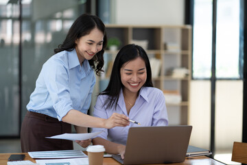 Businesswoman working with female colleagues inside the office.