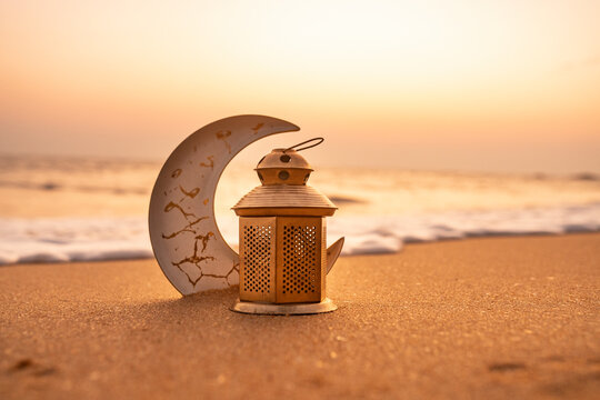 Traditional Candle light with Crescent moon shape on the beach, Ramadan Kareem background 2024