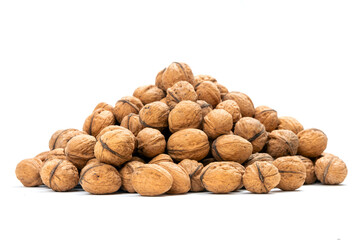 Heap of unpeeled nuts over white background