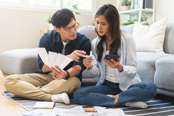 Stressed financial owe asian young couple love sitting suffer, stressed and confused by calculate...