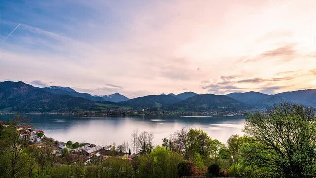 Time-lapse video with the breathtaking alpine landscape around Tegernsee in Bavaria, Germany. The clouds pass by while the sun sets behind the mountain range.