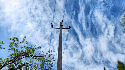 Closeup of old power poles on a clear summer day. Old hight voltage electric pole with wires and...