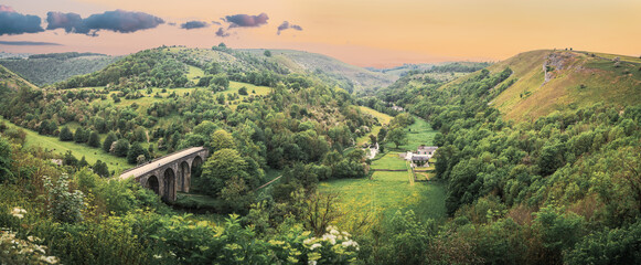 Panoramic landscape from Monsal Head looking down to the Monsal trail viaduct in Derbyshire Peak...