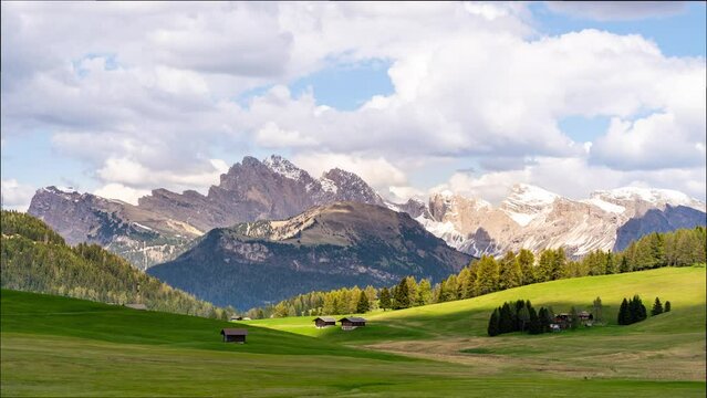 Timelapse video of passing clouds with alpine landscape of the Seiser Alm (Alpe di Siusi) meadow in the Dolomites. The Puez-Geisler mountain range dominates the stunning landscape.
