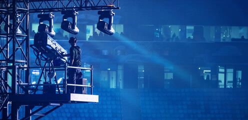 A man controls the lighting equipment. Checking stage equipment. Concert equipment. Director of the world.