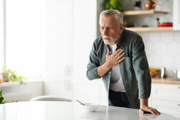 Heart Attack. Senior man suffering from chest pain at home - Powered by Adobe