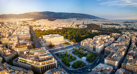 Panoramic aerial view of the City Center of Athens, Greece, with Syntagma Square and Parliament building during golden sunset time