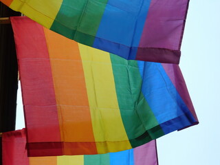 Pride rainbow lgbt gay flag being waved on sky background