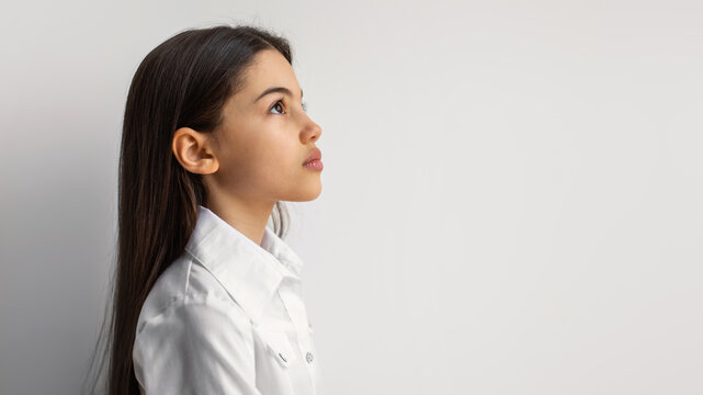 Side View Portrait Of Serious Arabic Girl On White Background