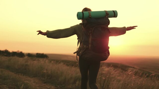 young girl raises her hands up sunset, female travel, summer camping trip, tourist female backpack, big travel bag, running towards sun, happy woman, long hair wind, female running nature, vacation