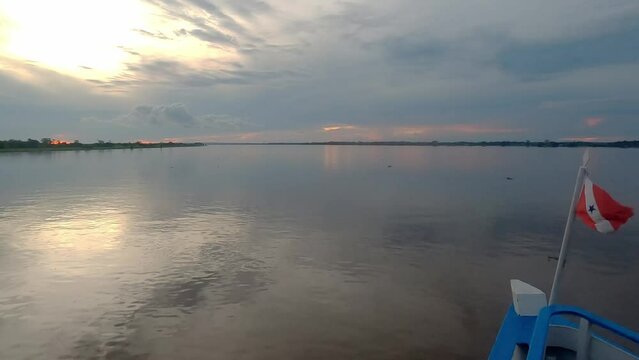 sailing the amazon river in the Brazilian amazon rainforest during sunset 