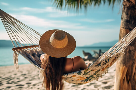 Back view of a young woman in a hammock on a tropical sandy beach during the sunset. High quality photo Generative AI