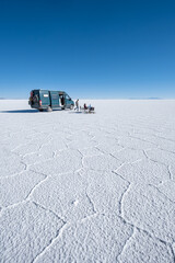 Family in a campervan having a picnic in the middle of a salt flat