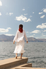 woman working with a tablet at home beautiful window light cozy, smiling looking at camera, showing camera, plants