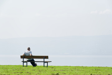 Man sitting alone on seat relaxing with sea view