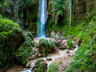 Waterfall of Nemouta in Peloponnese in Greece in a green gorge and cave