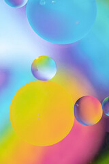 Bright beautiful balls. Oil drops in water and air bubbles, macro photo, selective focus.