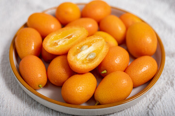 Delicious small citrus fruits orange kumquats close up