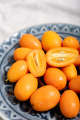Delicious small citrus fruits orange kumquats close up