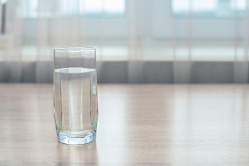 A glass of water on a wooden table