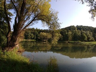 Fototapeta na wymiar River, lake or the brook flowing in the wild nature. Slovakia