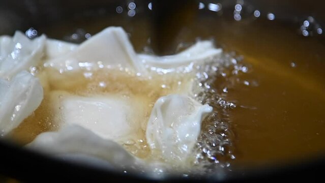 Crispy Delights: Tempting Slow Motion Video of Batata or Membrillo Pastelitos Frying in Flavorful Peya Fat