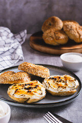 Creme brulee bagels with cream cheese and caramelized sugar on a plate vertical view