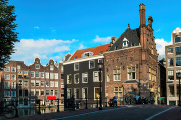Fototapeta premium Old building and bridge over canal in Amsterdam, Netherlands.