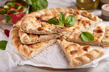 Thin closed pie with chicken meat, cheese and herbs. Savory taste. 