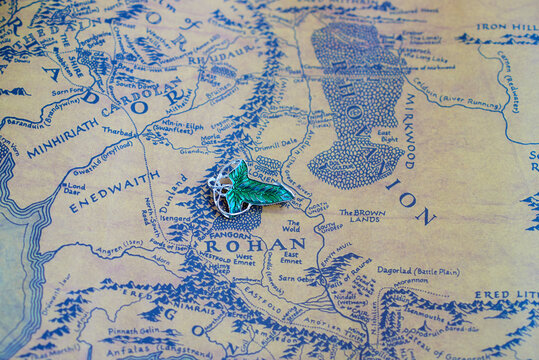 Astrakhan, Russia - 05.12.2021: Elven Lorien brooch lies on Middle-Earth map