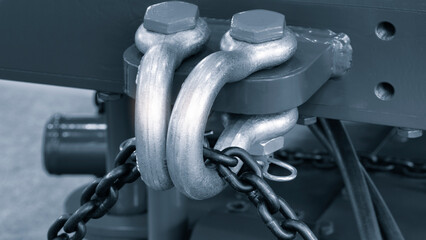 Metal shackle with chain for lifting or towing heavy objects in the workshop. Industrial concept...