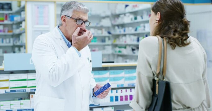 Pharmacist, man and help customer with medicine, pills or medication in pharmacy. Pharmaceutical, senior and sick woman with doctor explaining drugs, medical product and direction for healthcare.