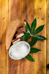 pile of cassava, cassava and cassava flour on a background of rustic wood (Manihot esculenta)